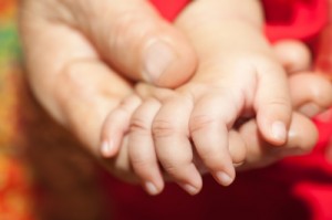 Mother holding child's hand